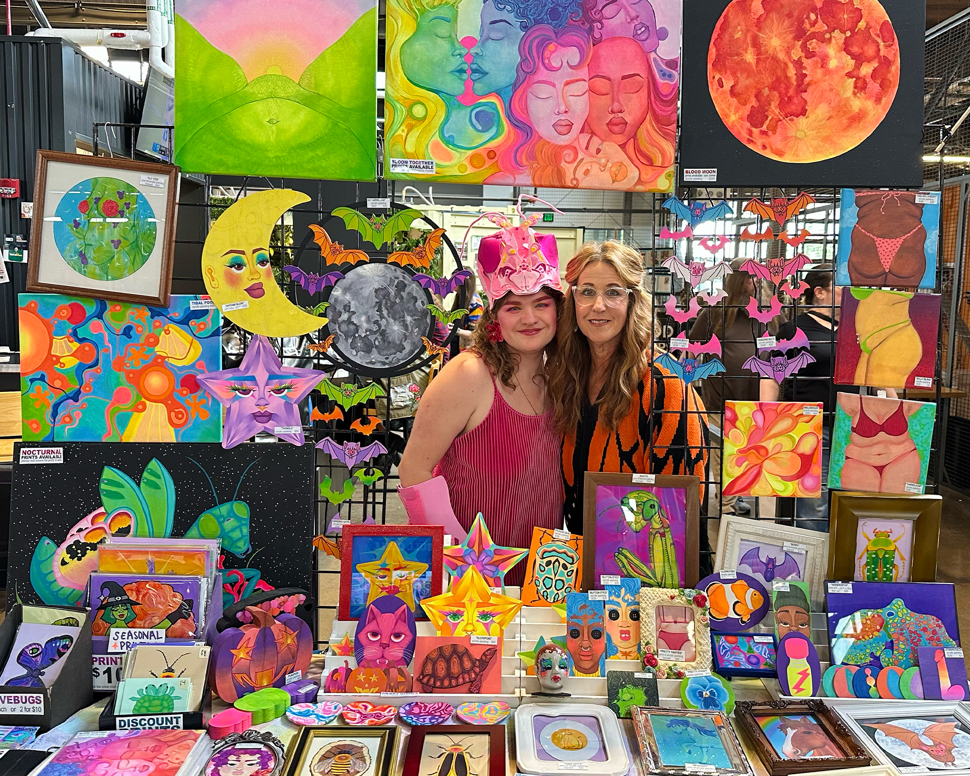 bowie and parent at market with art display